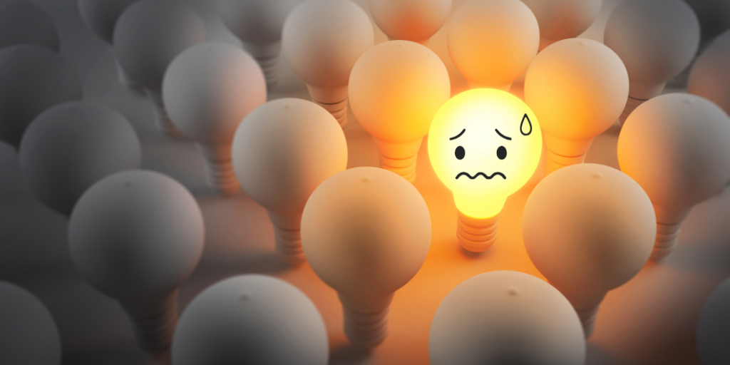 Glowing lightbulb with a worried face among dim bulbs, representing avoidance