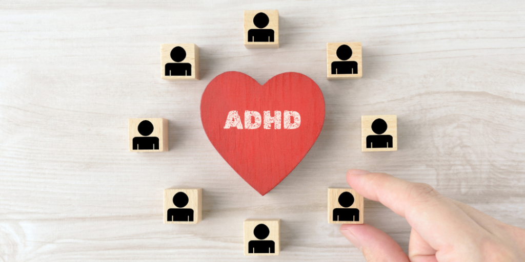 Red wooden heart marked ADHD surrounded by blocks with person icons, representing ADHD in relationships